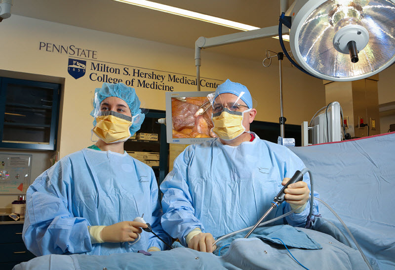 Two physicians perfom minimally invasive surgery in a Penn State Hershey operating room.