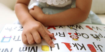 Child reading an open book.