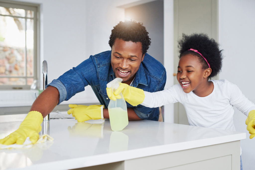 Shot of a little girl and her father enjoying their chores at home