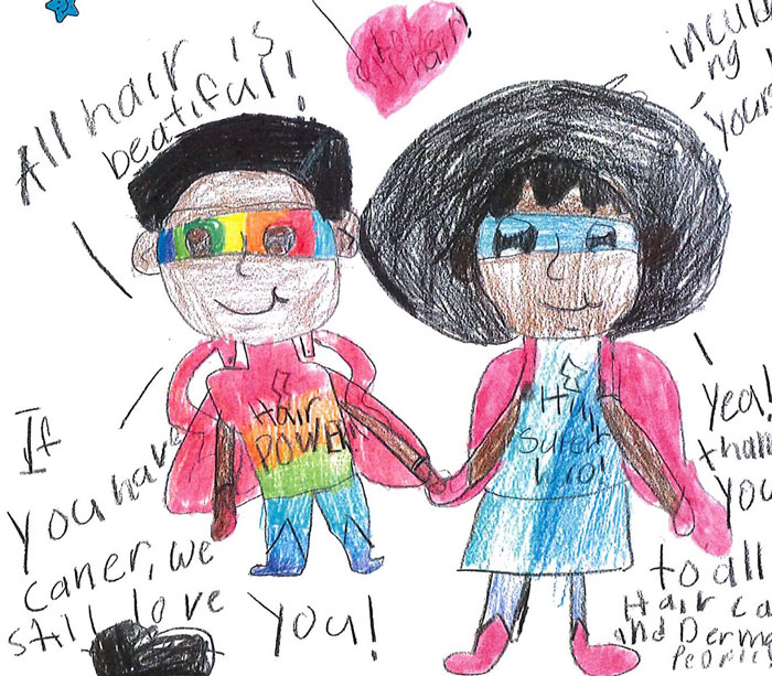 A child’s crayon drawing shows a boy and a girl, both wearing superhero masks, smiling and holding hands. Among the many words written around the figures are “All Hair is Beautiful.”