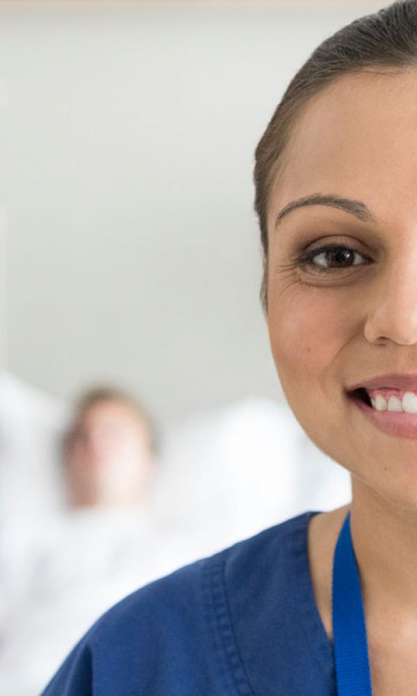 Happy female medical professional looking at camera. Head and shoulder  portrait of female nurse.