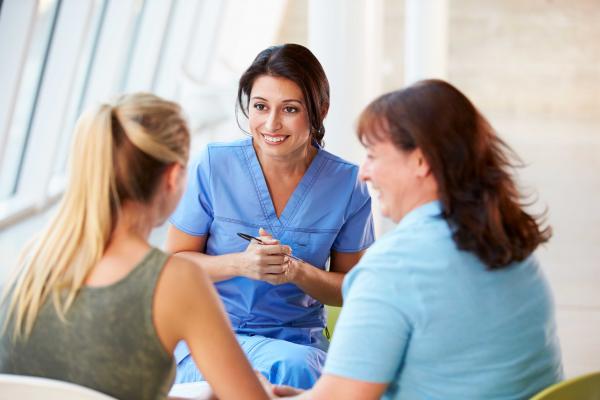 Three women sitting in a circle having a discussion