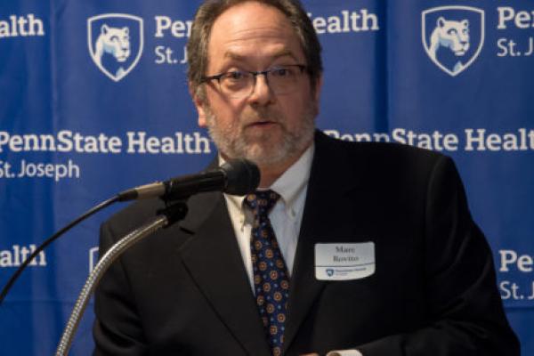 A man speaks at a podium