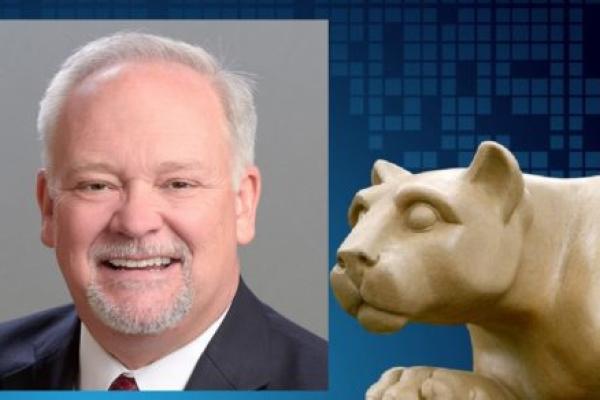 A portrait of Edward Chabalowski is positioned next to a statue of the Penn State Nittany Lion.