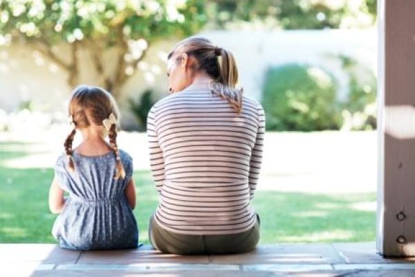 Rearview shot of a young woman and her daughter having a conversation on the porch