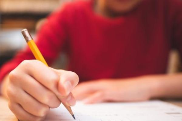 Hands of a child studying