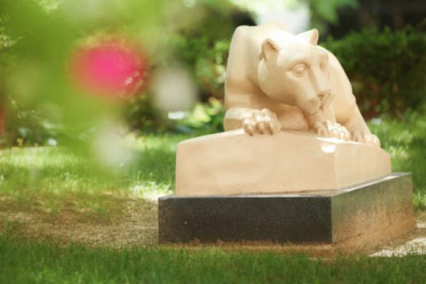 Penn State College of Medicine's Nittany lion statue is seen in a courtyard in the spring.