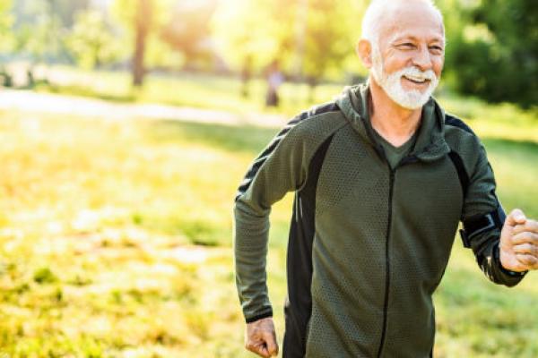 A man jogs outdoors on a spring day.