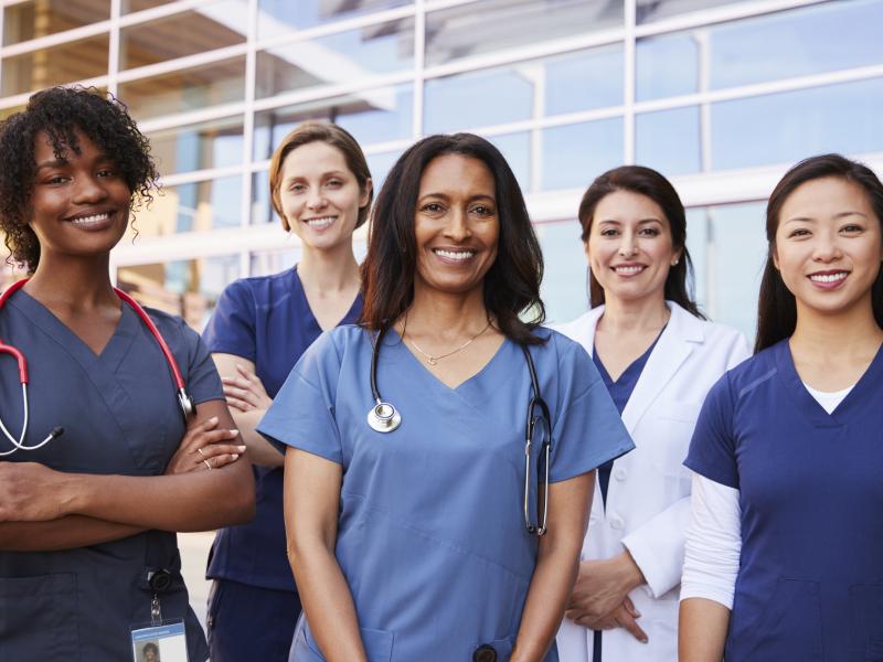 Healthcare workers smile for the camera.